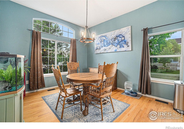 2502 Ballard Ln, Fort Collins, CO 80524 - dining space featuring light wood-style flooring, a chandelier, and baseboards