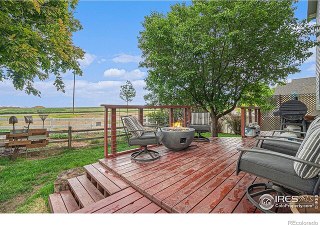 2502 Ballard Ln, Fort Collins, CO 80524 - wooden terrace with an outdoor fire pit and a rural view