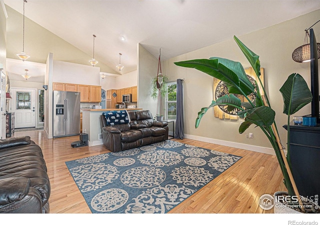 2502 Ballard Ln, Fort Collins, CO 80524 - living area featuring light wood-style floors, baseboards, and high vaulted ceiling