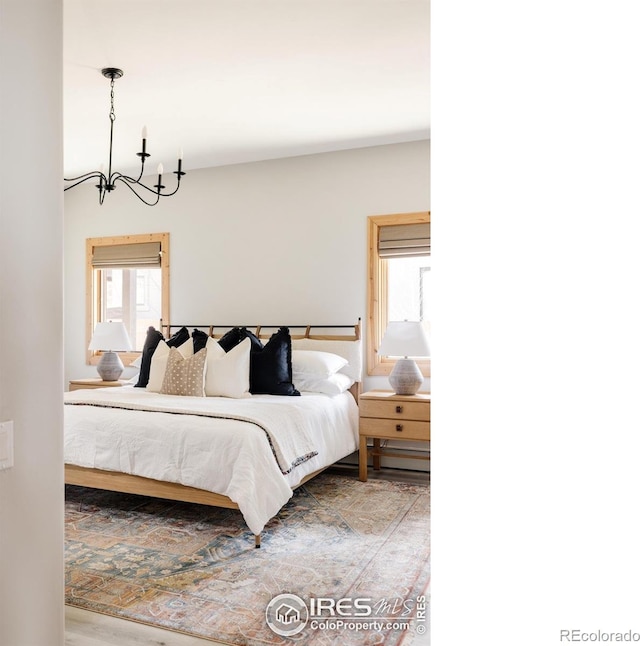320 Elk Ln, Grand Lake, CO 80447 - bedroom featuring a chandelier and wood finished floors
