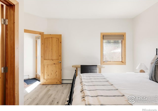320 Elk Ln, Grand Lake, CO 80447 - bedroom with light wood-style floors, a baseboard radiator, and baseboards