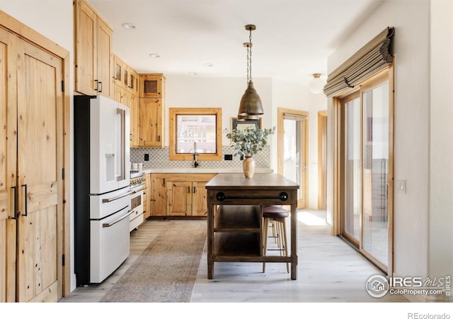 320 Elk Ln, Grand Lake, CO 80447 - kitchen featuring high quality appliances, light brown cabinetry, light wood-style flooring, and tasteful backsplash