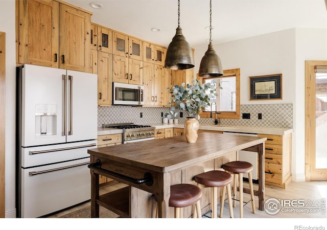 320 Elk Ln, Grand Lake, CO 80447 - kitchen featuring high end fridge, range, butcher block counters, tasteful backsplash, and glass insert cabinets