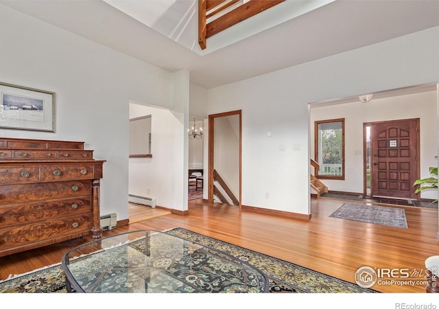 4157 19th St, Boulder, CO 80304 - foyer entrance with a baseboard radiator, wood finished floors, and a chandelier
