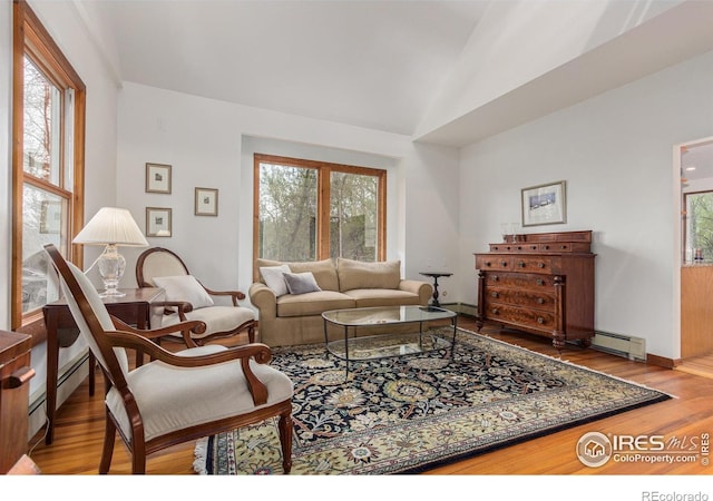 4157 19th St, Boulder, CO 80304 - living area featuring vaulted ceiling, wood finished floors, baseboard heating, and baseboards