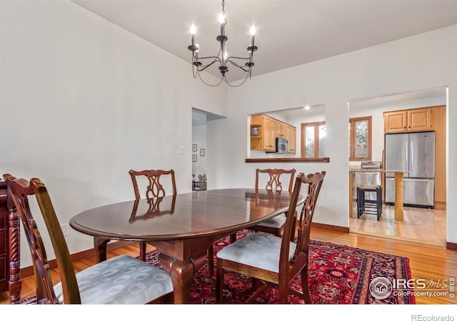 4157 19th St, Boulder, CO 80304 - dining room with a chandelier, light wood-style flooring, and baseboards