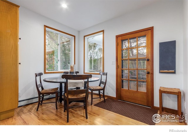 4157 19th St, Boulder, CO 80304 - dining room with light wood-style floors, a baseboard radiator, and baseboards