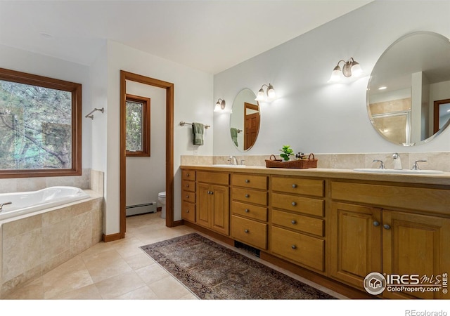 4157 19th St, Boulder, CO 80304 - full bath with baseboard heating, double vanity, a garden tub, toilet, and tile patterned flooring