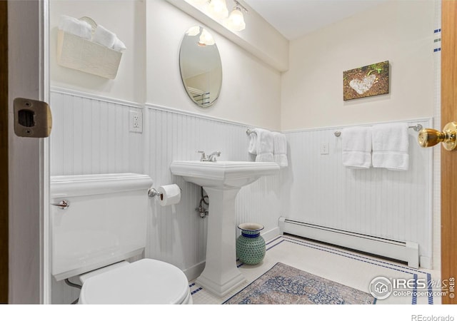 4157 19th St, Boulder, CO 80304 - half bathroom featuring a baseboard radiator, a wainscoted wall, and toilet