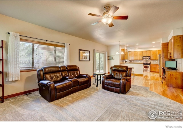 1414 Sheep Creek Ct, Fort Collins, CO 80526 - living room featuring healthy amount of natural light, a ceiling fan, baseboards, recessed lighting, and light carpet