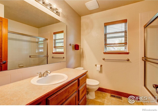 1414 Sheep Creek Ct, Fort Collins, CO 80526 - bathroom featuring toilet, vanity, baseboards, and shower / bath combination with glass door