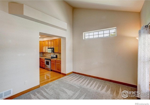 1414 Sheep Creek Ct, Fort Collins, CO 80526 - kitchen with stainless steel appliances, light colored carpet, decorative backsplash, baseboards, and brown cabinetry