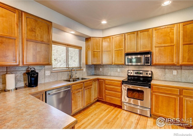 1414 Sheep Creek Ct, Fort Collins, CO 80526 - kitchen featuring stainless steel appliances, a sink, light countertops, light wood-style flooring, and recessed lighting
