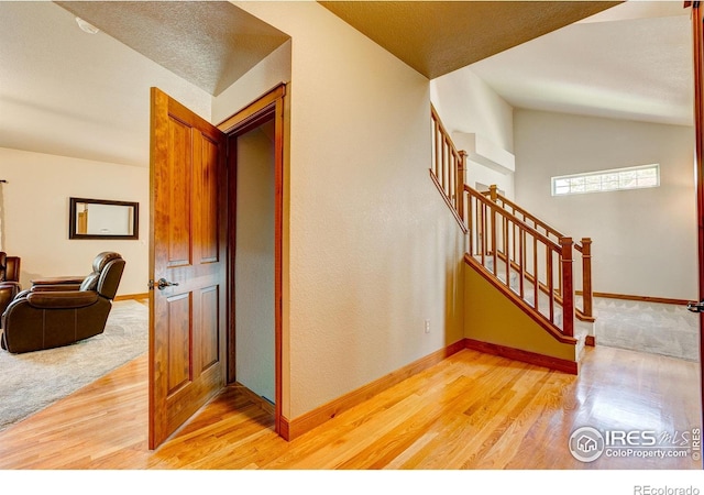 1414 Sheep Creek Ct, Fort Collins, CO 80526 - staircase with wood finished floors, lofted ceiling, and baseboards