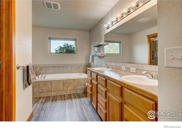 1414 Sheep Creek Ct, Fort Collins, CO 80526 - full bath featuring wood finished floors, a bath, double vanity, and a textured wall