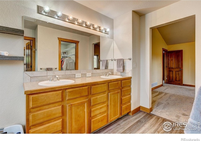 1414 Sheep Creek Ct, Fort Collins, CO 80526 - full bathroom featuring double vanity, a walk in closet, wood finished floors, and baseboards