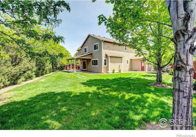 1414 Sheep Creek Ct, Fort Collins, CO 80526 - view of grassy yard with a patio and an attached garage