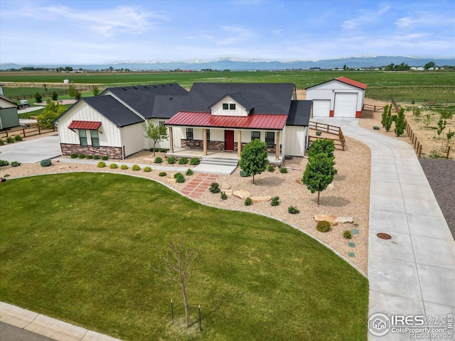 5031 Prairie Lark Ln, Severance, CO 80615 - view of front of home with a porch, a view of countryside, a front lawn, and concrete driveway