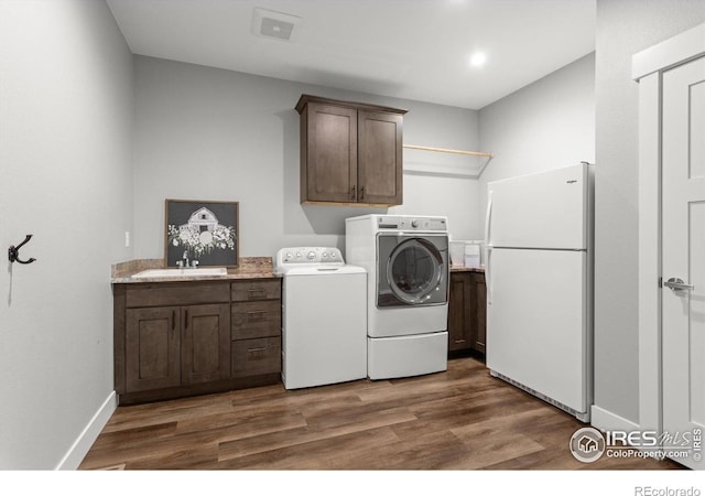 5031 Prairie Lark Ln, Severance, CO 80615 - washroom featuring cabinet space, washing machine and dryer, dark wood-style floors, baseboards, and recessed lighting