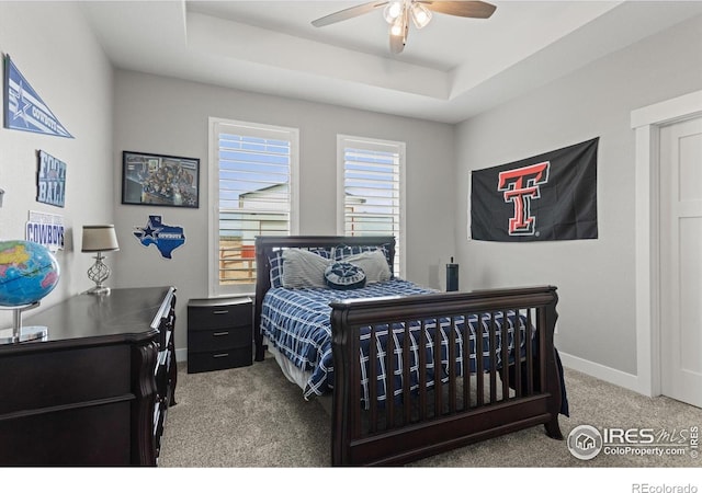 5031 Prairie Lark Ln, Severance, CO 80615 - bedroom featuring carpet floors, baseboards, a tray ceiling, ceiling fan, and an office area
