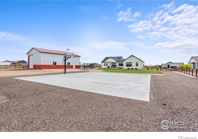 5031 Prairie Lark Ln, Severance, CO 80615 - view of property's community with concrete driveway, an outdoor structure, and community basketball court