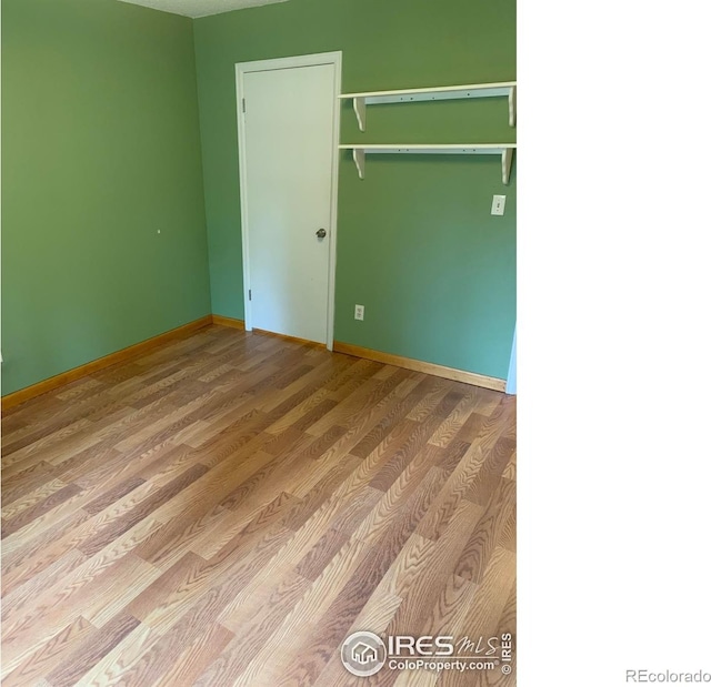 3250 Oneal Cir Unit 14, Boulder, CO 80301 - unfurnished bedroom with wood finished floors, baseboards, and a closet