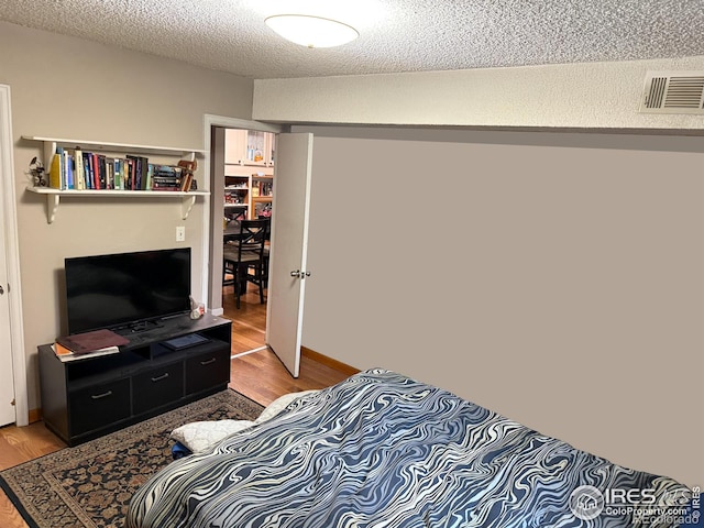 3250 Oneal Cir Unit 14, Boulder, CO 80301 - bedroom with light wood-type flooring and a textured ceiling