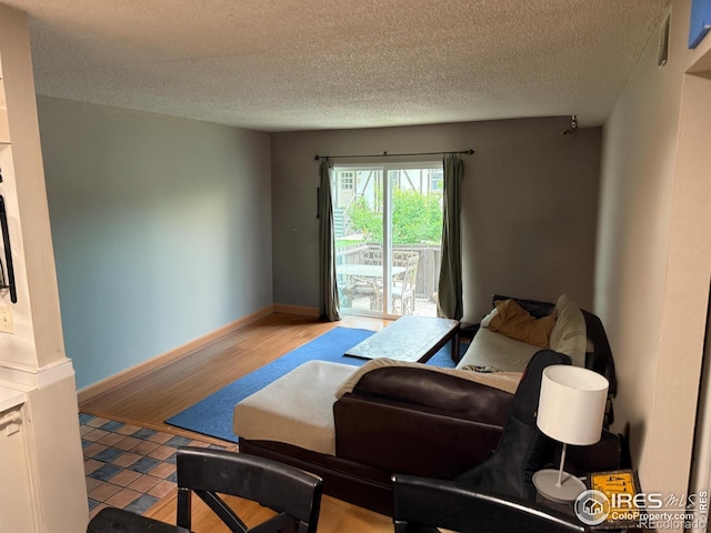 3250 Oneal Cir Unit 14, Boulder, CO 80301 - living area featuring a textured ceiling, wood finished floors, and baseboards