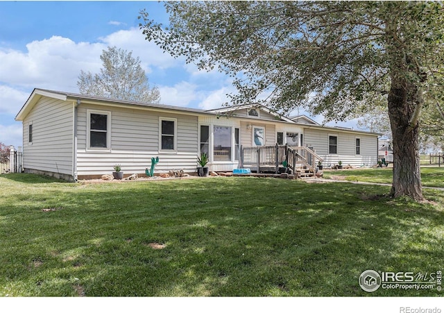 10635 County Road 24, Fort Lupton, CO 80621 - view of front of home featuring a front yard and a wooden deck