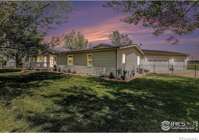 10635 County Road 24, Fort Lupton, CO 80621 - back of house at dusk with driveway and a garage