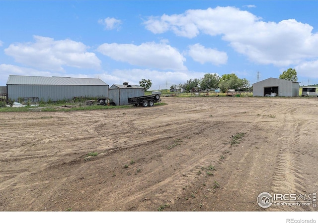 10635 County Road 24, Fort Lupton, CO 80621 - view of yard with a pole building, an outbuilding, and a garage