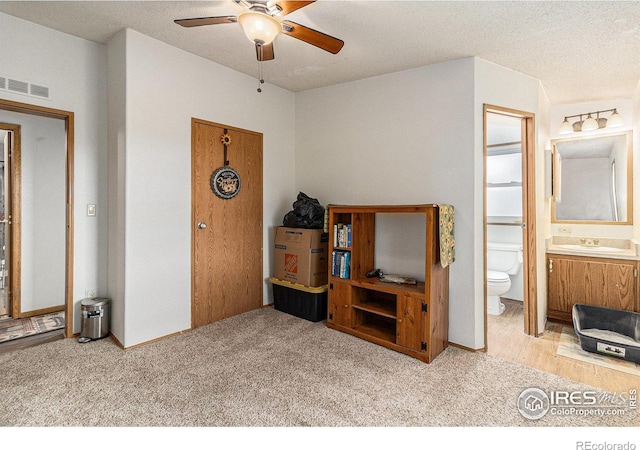 10635 County Road 24, Fort Lupton, CO 80621 - carpeted bedroom with ensuite bath and a textured ceiling