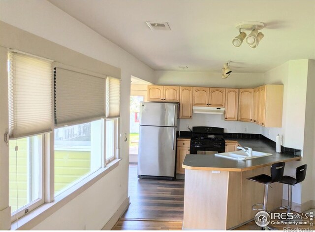 936 Parkview St, Louisville, CO 80027 - kitchen featuring freestanding refrigerator, black gas range oven, a sink, light brown cabinets, and plenty of natural light