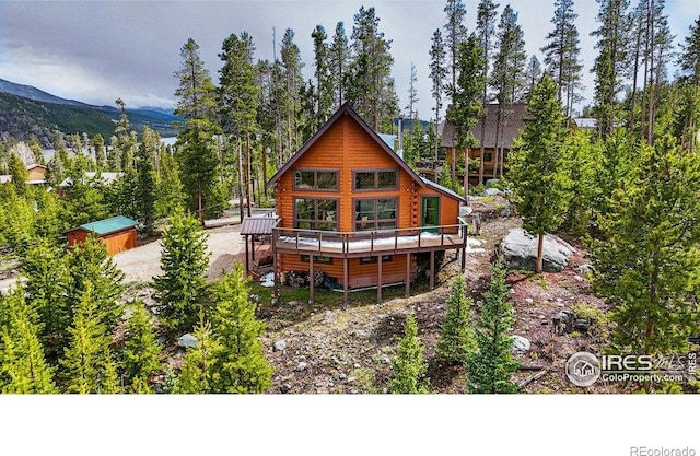 47 County Road 471, Grand Lake, CO 80447 - rear view of house featuring a deck with mountain view, log exterior, and an outdoor structure