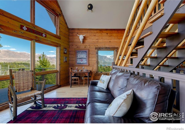 47 County Road 471, Grand Lake, CO 80447 - living room with a mountain view, wood finished floors, wooden walls, lofted ceiling, and stairway