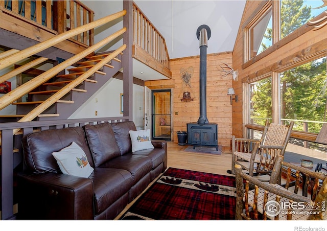 47 County Road 471, Grand Lake, CO 80447 - living room with a high ceiling, a wood stove, wood walls, and wood finished floors