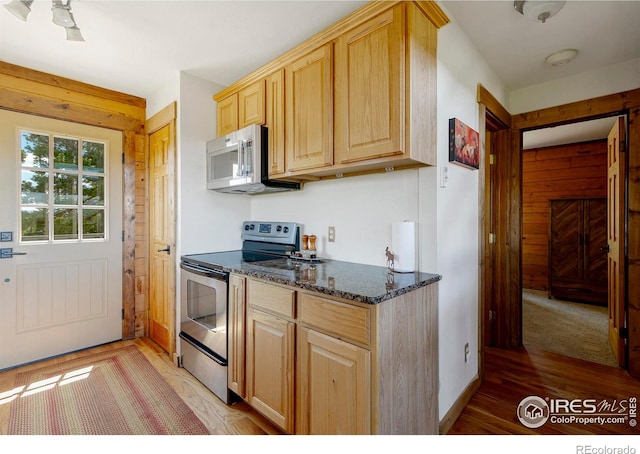 47 County Road 471, Grand Lake, CO 80447 - kitchen with appliances with stainless steel finishes, light wood-style floors, light brown cabinets, and dark stone counters