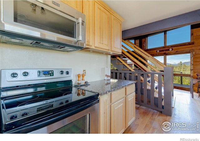 47 County Road 471, Grand Lake, CO 80447 - kitchen featuring appliances with stainless steel finishes, light brown cabinets, light wood-style floors, and dark stone countertops