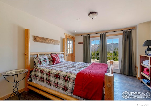 47 County Road 471, Grand Lake, CO 80447 - bedroom featuring wood finished floors, multiple windows, and access to outside