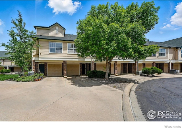 1837 Spaulding Cir, Superior, CO 80027 - townhome / multi-family property with brick siding, a garage, and driveway