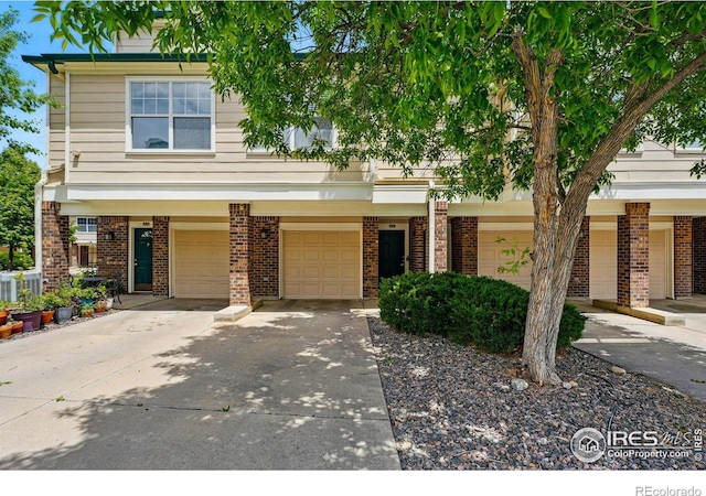 1837 Spaulding Cir, Superior, CO 80027 - townhome / multi-family property featuring driveway, brick siding, and a garage