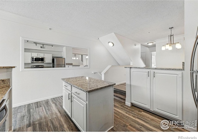 1837 Spaulding Cir, Superior, CO 80027 - kitchen with stainless steel appliances, white cabinetry, a textured ceiling, and dark wood-style flooring