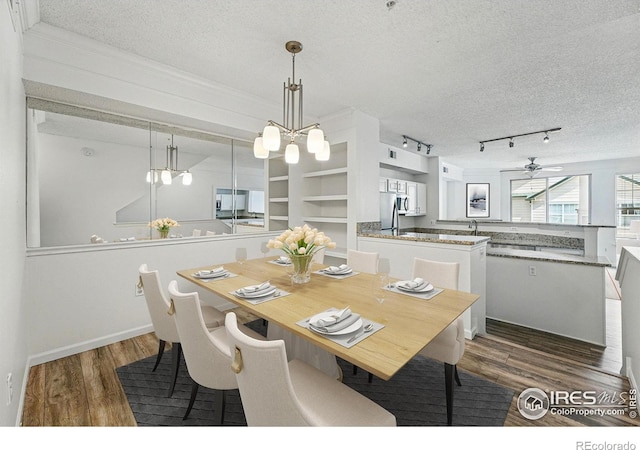 1837 Spaulding Cir, Superior, CO 80027 - dining area with a textured ceiling, wood finished floors, a ceiling fan, a chandelier, and track lighting