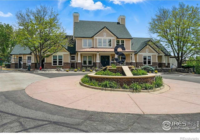 1837 Spaulding Cir, Superior, CO 80027 - view of front of property with a chimney, brick siding, and curved driveway