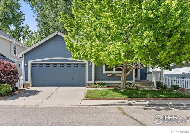 2106 River Walk Ln, Longmont, CO 80504 - obstructed view of property featuring a garage and driveway