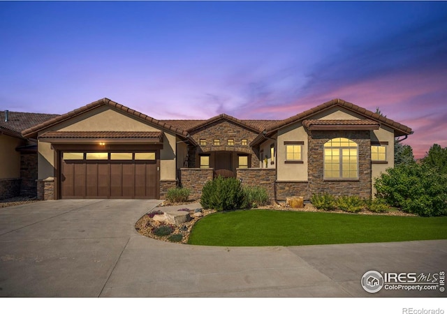 5112 Daylight Ct, Fort Collins, CO 80528 - view of front of home with stone siding, stucco siding, driveway, an attached garage, and a yard