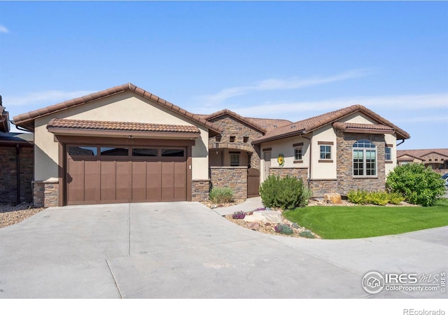 5112 Daylight Ct, Fort Collins, CO 80528 - mediterranean / spanish-style house featuring stone siding, stucco siding, an attached garage, and driveway