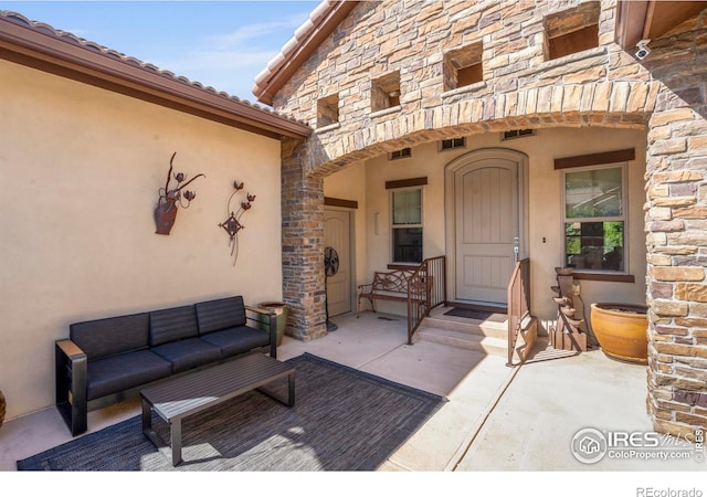 5112 Daylight Ct, Fort Collins, CO 80528 - doorway to property with stone siding, an outdoor living space, and stucco siding
