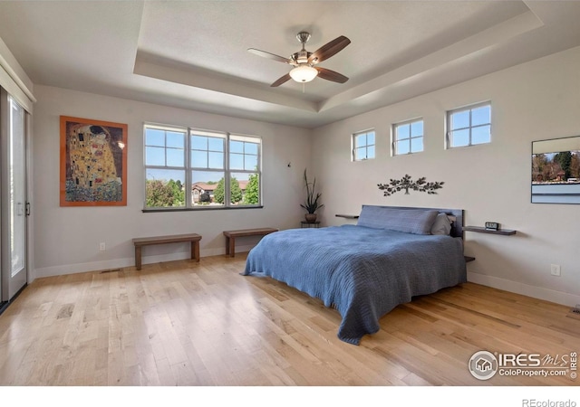 5112 Daylight Ct, Fort Collins, CO 80528 - bedroom featuring a raised ceiling, light wood finished floors, baseboards, and a ceiling fan