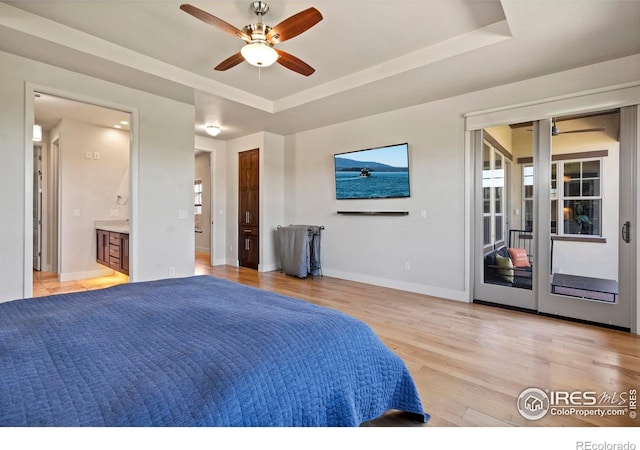 5112 Daylight Ct, Fort Collins, CO 80528 - bedroom featuring access to outside, light wood-type flooring, baseboards, a tray ceiling, and ensuite bath